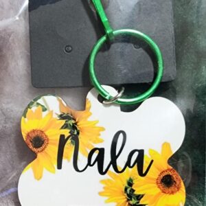 Product image of a dog tag pet ID tag with the name "Nala" written in cursive. Product is packaged.